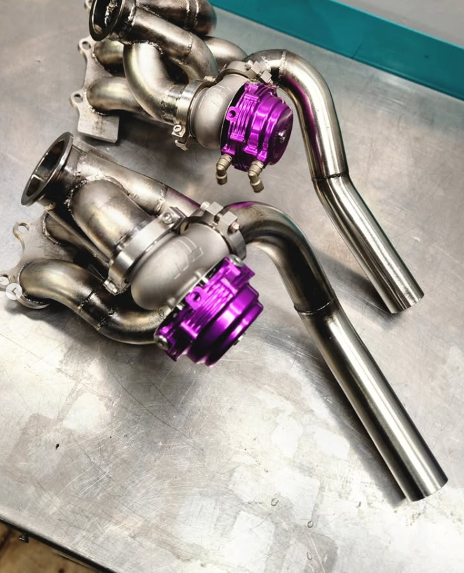 Same twin Precision turbos and custom manifolds after refresh, fitted with purple TIAL-style wastegates